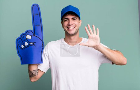 Photo for Adult man smiling happily, waving hand, welcoming and greeting you. number one fan concept - Royalty Free Image