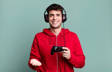Photo for Adult man smiling happily with friendly and  offering and showing a concept with headset and a controller. gamer concept - Royalty Free Image