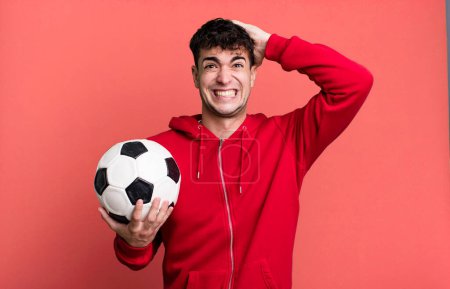 Photo for Adult man feeling stressed, anxious or scared, with hands on head. soccer and sport concept - Royalty Free Image