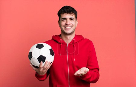 Photo for Adult man smiling happily with friendly and  offering and showing a concept. soccer and sport concept - Royalty Free Image
