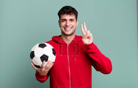 Photo for Adult man smiling and looking friendly, showing number two. soccer and sport concept - Royalty Free Image