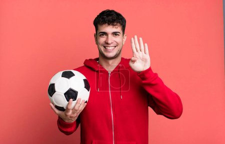 Photo for Adult man smiling and looking friendly, showing number four. soccer and sport concept - Royalty Free Image