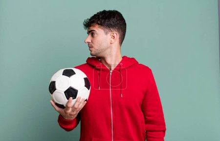 Photo for Adult man on profile view thinking, imagining or daydreaming. soccer and sport concept - Royalty Free Image