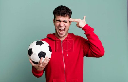Photo for Adult man looking unhappy and stressed, suicide gesture making gun sign. soccer and sport concept - Royalty Free Image