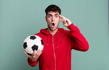 Photo for Adult man looking surprised, realizing a new thought, idea or concept. soccer and sport concept - Royalty Free Image
