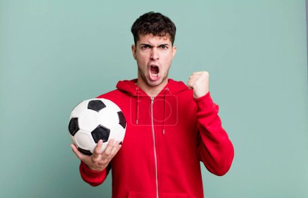 Photo for Adult man shouting aggressively with an angry expression. soccer and sport concept - Royalty Free Image
