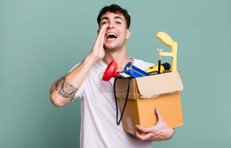 Photo for Adult man feeling happy,giving a big shout out with hands next to mouth with a toolbox. housekeeper concept - Royalty Free Image