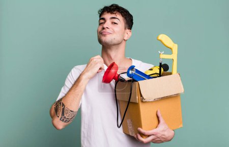 Photo for Adult man looking arrogant, successful, positive and proud with a toolbox. housekeeper concept - Royalty Free Image