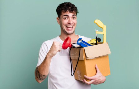 Photo for Adult man feeling happy and facing a challenge or celebrating with a toolbox. housekeeper concept - Royalty Free Image