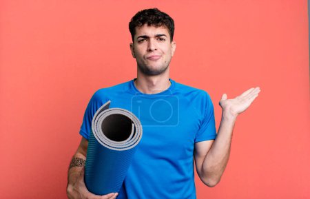 Photo for Adult man feeling puzzled and confused and doubting. fitness and yoga concept - Royalty Free Image
