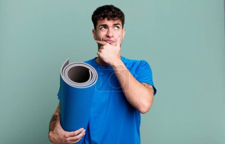Photo for Adult man thinking, feeling doubtful and confused. fitness and yoga concept - Royalty Free Image