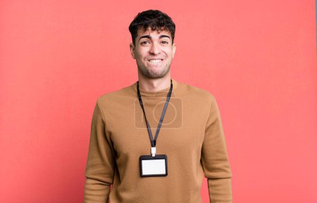 Photo for Adult man looking puzzled and confused with an acccess identity card - Royalty Free Image