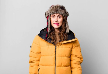 Photo for Hispanic pretty woman looking puzzled and confused. wearing an anorak. cold and winter concept - Royalty Free Image