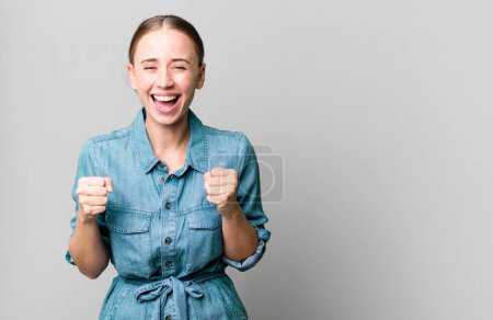 Photo for Caucasian pretty woman feeling shocked,laughing and celebrating success - Royalty Free Image