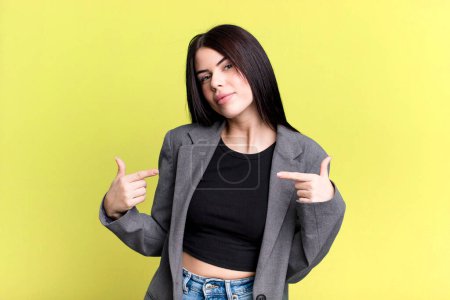 Photo for Young adult pretty woman looking proud, arrogant, happy, surprised and satisfied, pointing to self, feeling like a winner - Royalty Free Image