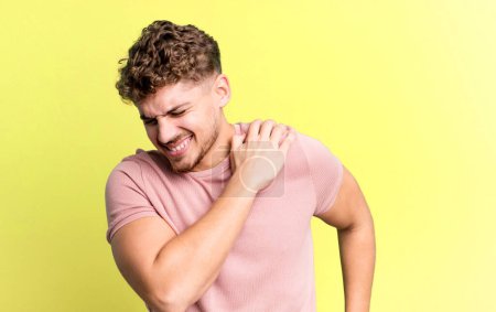 Photo for Young adult caucasian man feeling tired, stressed, anxious, frustrated and depressed, suffering with back or neck pain - Royalty Free Image