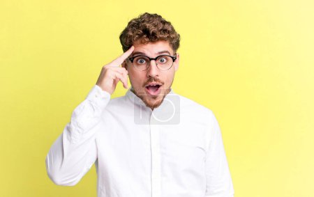 Photo for Young adult caucasian man looking surprised, open-mouthed, shocked, realizing a new thought, idea or concept - Royalty Free Image