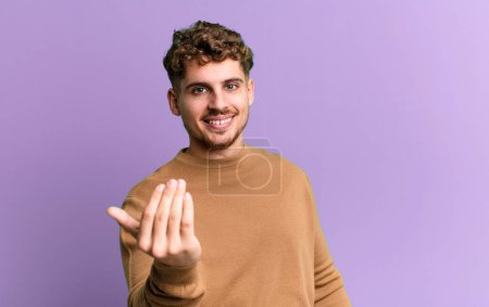 Photo for Young adult caucasian man feeling happy, successful and confident, facing a challenge and saying bring it on! or welcoming you - Royalty Free Image