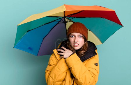 Photo for Caucasian pretty blonde woman with an umbrella. winter and cold concept - Royalty Free Image