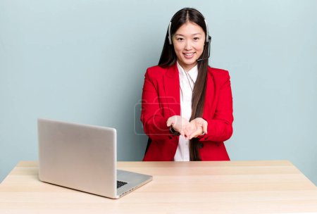 Photo for Pretty asian woman smiling happily with friendly and  offering and showing a concept. business desk concept - Royalty Free Image