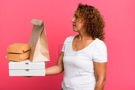 Photo for On profile view thinking, imagining or daydreaming. take away fast food delivery concept. - Royalty Free Image