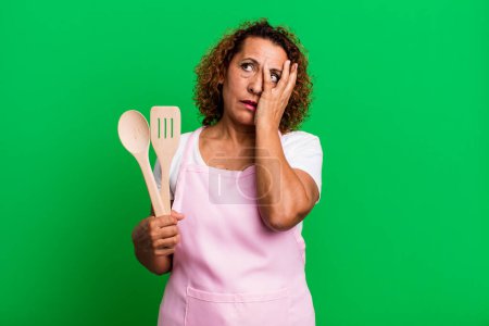 Photo for Pretty middle age woman feeling bored, frustrated and sleepy after a tiresome. home wife chef concept - Royalty Free Image
