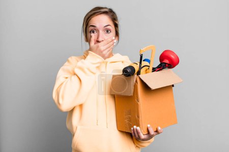 Photo for Pretty blonde woman covering mouth with hands with a shocked. tool box and repair concept - Royalty Free Image