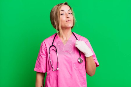 Photo for Pretty blonde woman looking arrogant, successful, positive and proud. nurse concept - Royalty Free Image