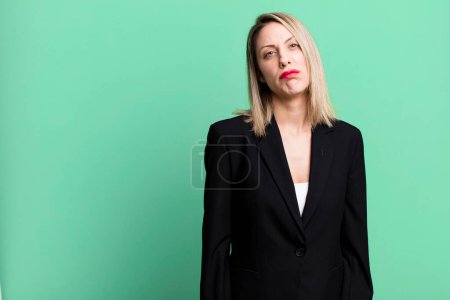 Téléchargez les photos : Pretty blonde woman feeling sad and whiney with an unhappy look and crying. businesswoman concept - en image libre de droit