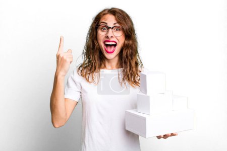 Photo for Hispanic pretty woman feeling like a happy and excited genius after realizing an idea. with white boxes packages - Royalty Free Image