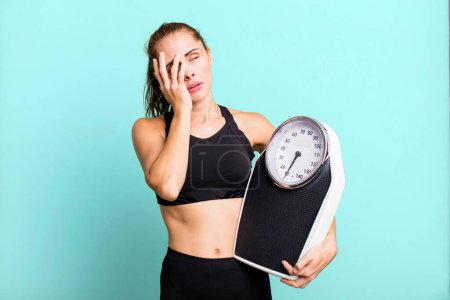 Photo for Hispanic pretty woman feeling bored, frustrated and sleepy after a tiresome. fitness, diet and weight scale concept - Royalty Free Image