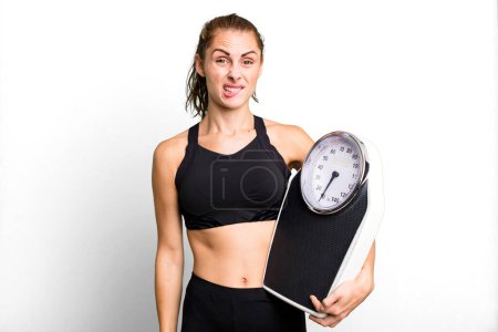 Photo for Hispanic pretty woman looking puzzled and confused. fitness, diet and weight scale concept - Royalty Free Image
