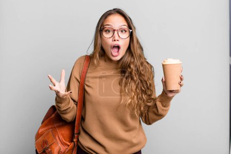 Photo for Hispanic pretty woman feeling extremely shocked and surprised. take away coffee concept - Royalty Free Image