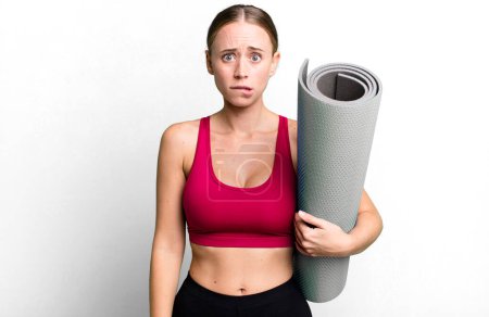 Photo for Caucasian pretty woman looking puzzled and confused. fitness and yoga concept - Royalty Free Image