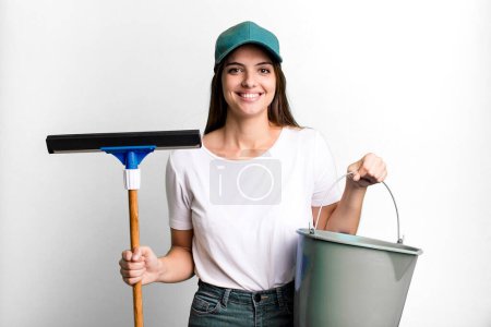 Photo for Young pretty woman housekeeper cleaning the windows - Royalty Free Image