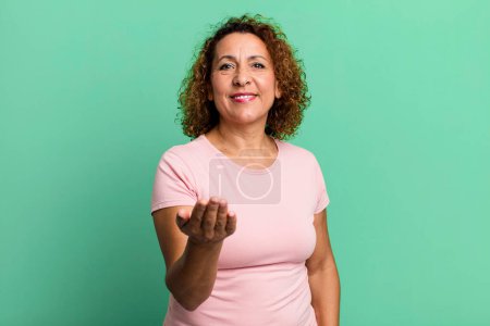 Photo for Middle age hispanic woman feeling happy, successful and confident, facing a challenge and saying bring it on! or welcoming you - Royalty Free Image