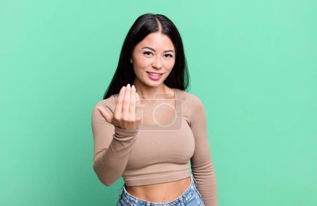 Téléchargez les photos : Pretty latin woman feeling happy, successful and confident, facing a challenge and saying bring it on! or welcoming you - en image libre de droit