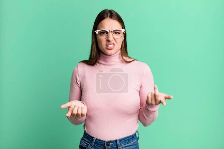 Photo for Pretty young adult woman feeling clueless and confused, not sure which choice or option to pick, wondering - Royalty Free Image