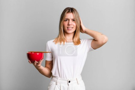 Photo for Young pretty woman feeling stressed, anxious or scared, with hands on head. japanese ramen noodles concept - Royalty Free Image