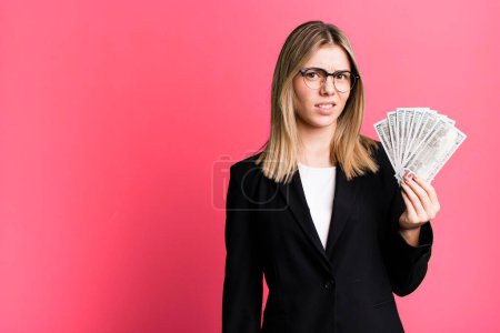 Photo for Young pretty woman feeling puzzled and confused. business and money concept - Royalty Free Image