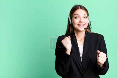 Photo for Young pretty woman feeling shocked,laughing and celebrating success. telemarketing agent concept - Royalty Free Image