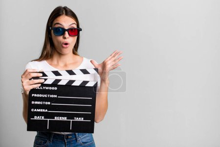 Photo for Young pretty woman screaming with hands up in the air. cinema film or movie concept - Royalty Free Image