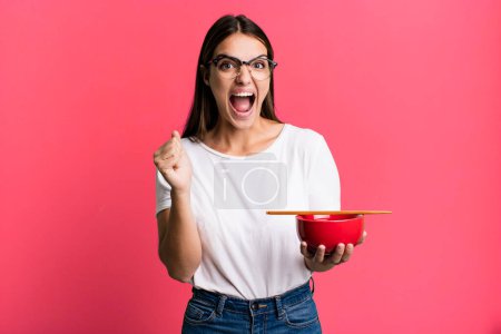 Photo for Young pretty woman shouting aggressively with an angry expression. japanese ramen noodles concept - Royalty Free Image