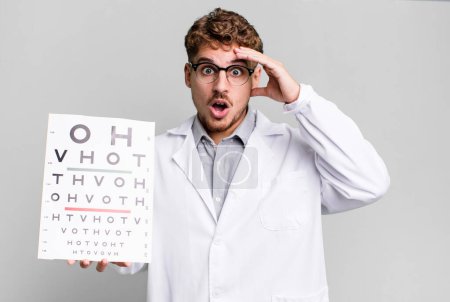 Photo for Young adult caucasian man looking happy, astonished and surprised. optical vision test concept - Royalty Free Image
