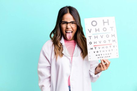 Photo for Hispanic pretty woman with cheerful and rebellious attitude, joking and sticking tongue out. optometry concept - Royalty Free Image