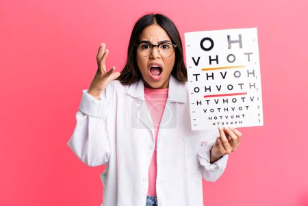 Photo for Hispanic pretty woman screaming with hands up in the air. optometry concept - Royalty Free Image