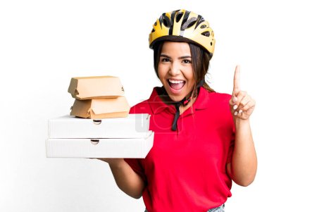 Photo for Hispanic pretty woman feeling like a happy and excited genius after realizing an idea.  delivery woman and take away concept - Royalty Free Image