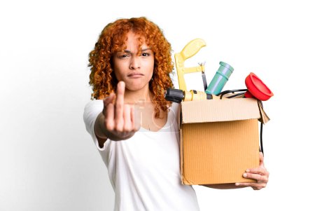 Photo for Red hair pretty woman feeling angry, annoyed, rebellious and aggressive. housekeeper and toolbox concept - Royalty Free Image