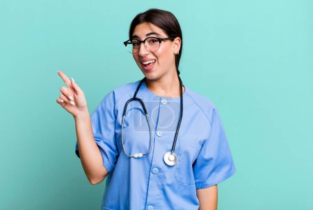 Photo for Looking excited and surprised pointing to the side. nurse concept - Royalty Free Image