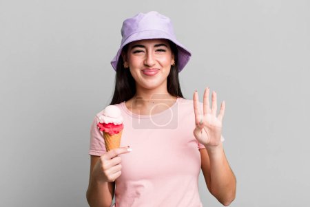 Téléchargez les photos : Smiling and looking friendly, showing number four. ice cream and summer concept - en image libre de droit